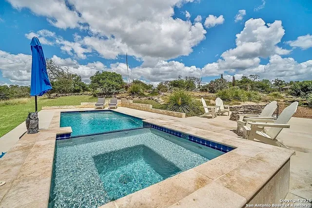 a view of a swimming pool with a lounge chairs