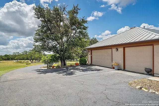 a view of a house with entertaining space and a tree