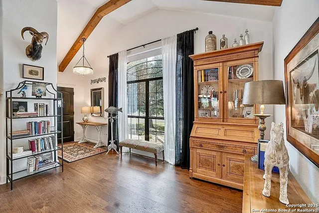 a living room with furniture and a floor to ceiling window