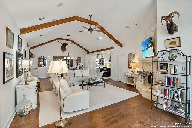 a living room with furniture and a book shelf