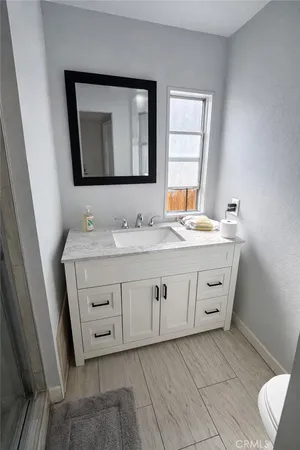 a bathroom with a double vanity sink and mirror