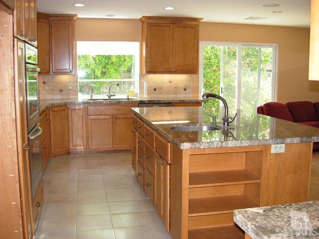2120 Outsail Lane Oxnard, CA 93035 - Photo 5 of 24 a kitchen with stainless steel appliances granite countertop a stove a sink and a refrigerator