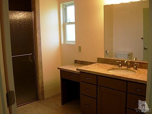 2120 Outsail Lane Oxnard, CA 93035 - Photo 10 of 24 a bathroom with a granite countertop sink and a mirror
