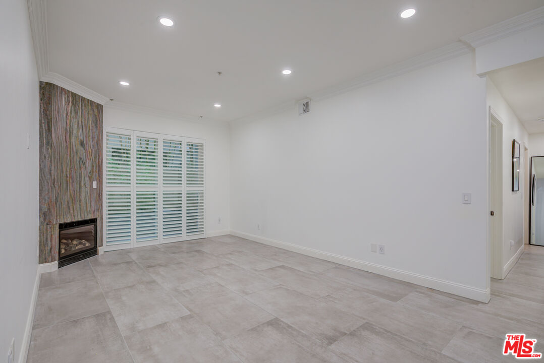 1444 South Point View Street, Unit 103 Los Angeles, CA 90035 - Photo 13 of 44 a view of an empty room with a fireplace
