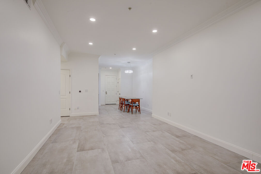 1444 South Point View Street, Unit 103 Los Angeles, CA 90035 - Photo 20 of 44 a view of an empty room with a washing machine