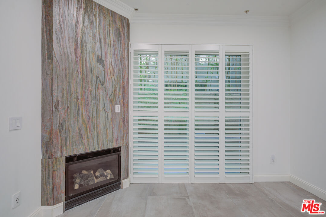 1444 South Point View Street, Unit 103 Los Angeles, CA 90035 - Photo 24 of 44 a view of an empty room with a fireplace and a window