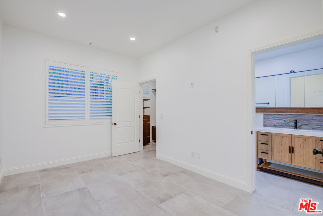 1444 South Point View Street, Unit 103 Los Angeles, CA 90035 - Photo 32 of 44 a view of an empty room with a window