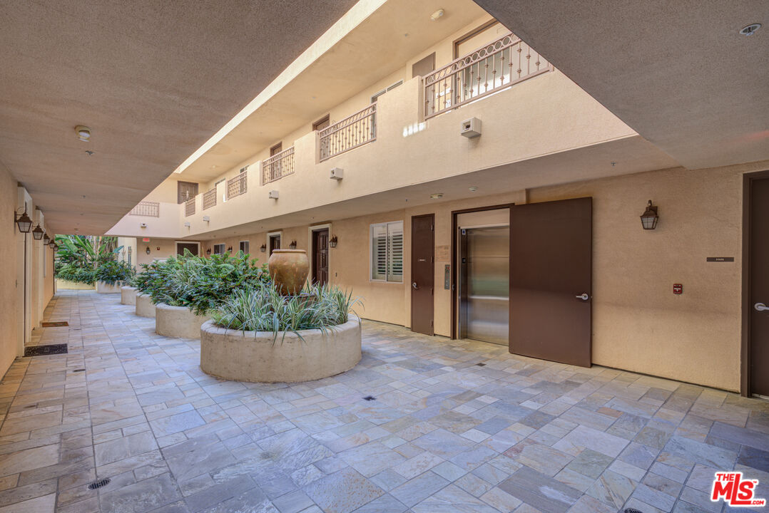 1444 South Point View Street, Unit 103 Los Angeles, CA 90035 - Photo 7 of 44 a view of a house with potted plants