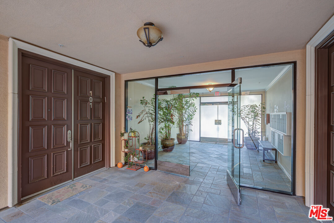 1444 South Point View Street, Unit 103 Los Angeles, CA 90035 - Photo 8 of 44 a view of an empty room with a fireplace and a window