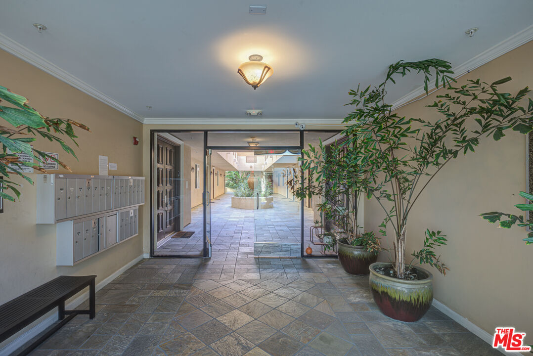 1444 South Point View Street, Unit 103 Los Angeles, CA 90035 - Photo 9 of 44 a living room with furniture and a potted plant