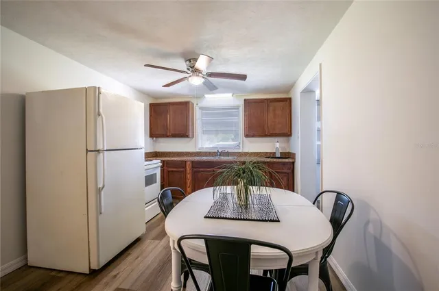 a view of a dining room with furniture and wooden floor