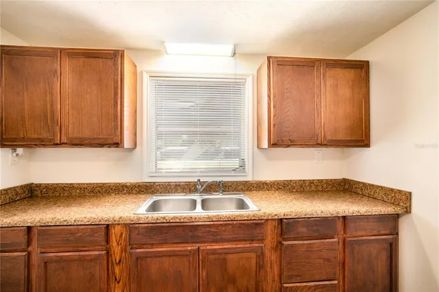 a kitchen with a sink cabinets and utility