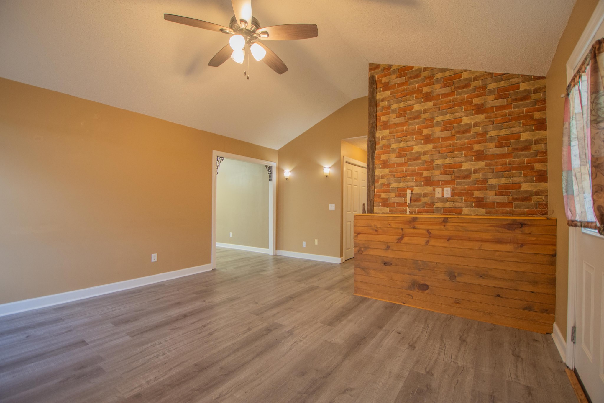 1149 Oak Grove Road Goodspring, TN 38460 - Photo 11 of 21 a view of a hallway with wooden floor and a chandelier fan