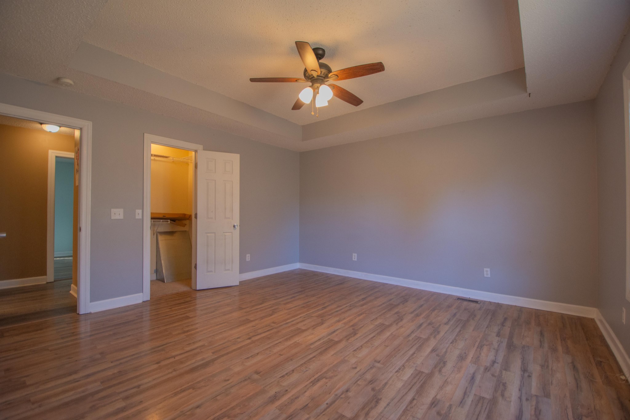 1149 Oak Grove Road Goodspring, TN 38460 - Photo 13 of 21 a view of an empty room with wooden floor and a ceiling fan