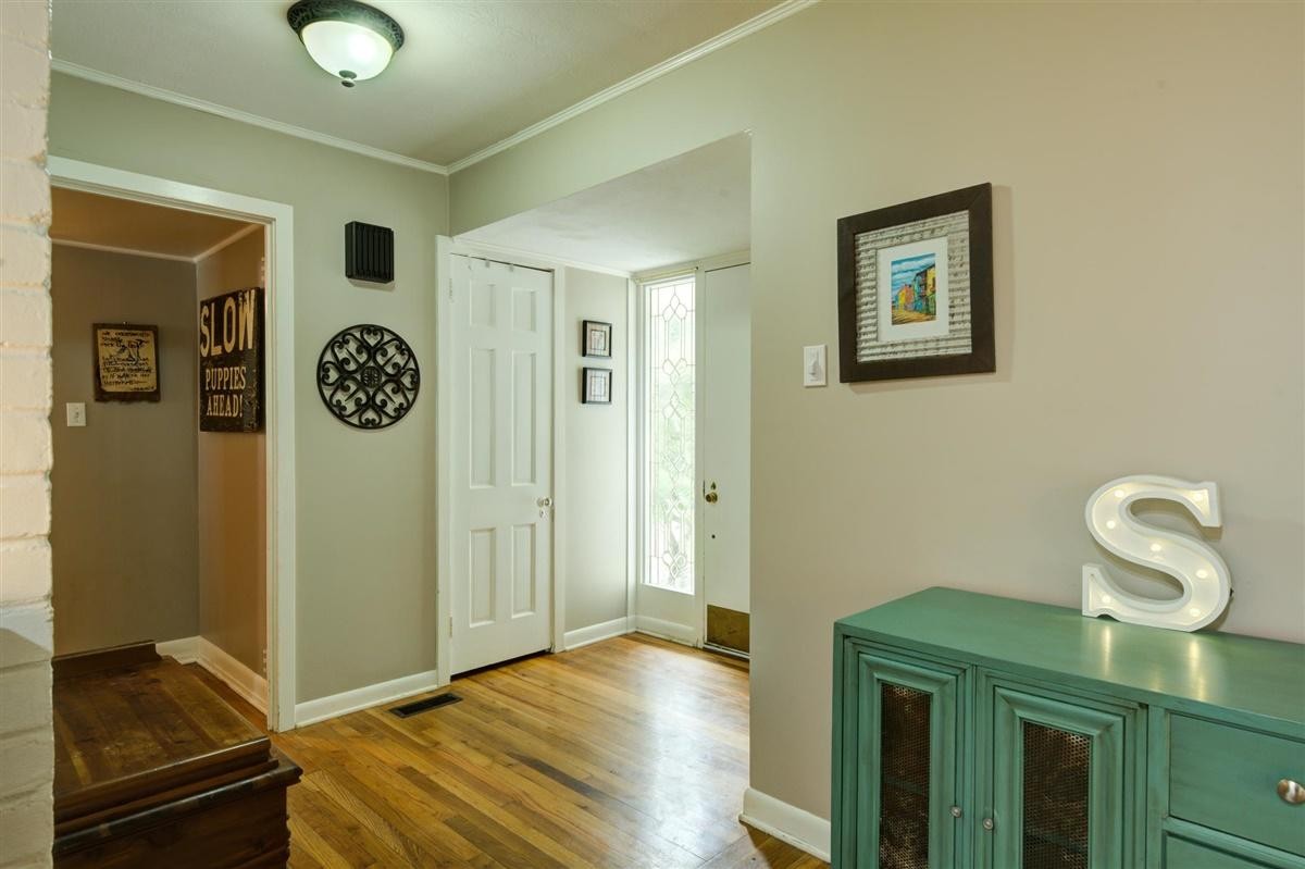 100 Osage Road Oak Ridge, TN 37830 - Photo 9 of 40 a bedroom with a bed and a chandelier