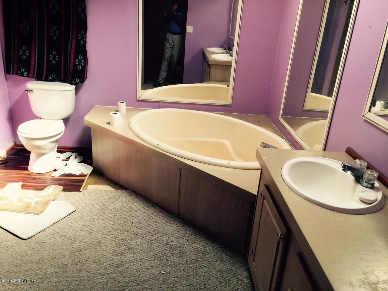960 Cherry Tree Road St. Augustine, FL 32086 - Photo 10 of 17 a bathroom with a sink and a mirror