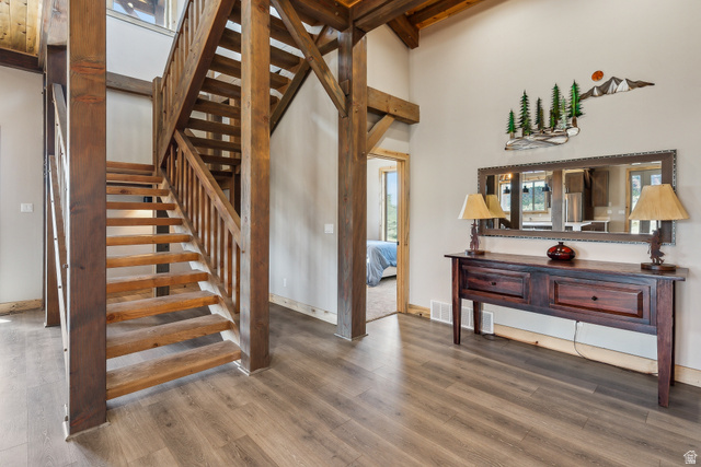 46997 West Thunder Road Fruitland, UT 84027 - Photo 10 of 49 Stairway featuring a towering ceiling, wood finished floors, and beamed ceiling