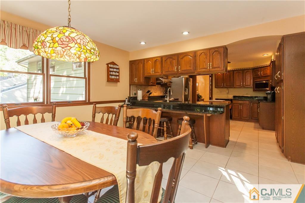18 Huntington Road Edison, NJ 08820 - Photo 3 of 21 a kitchen with stainless steel appliances granite countertop a sink a stove and a refrigerator