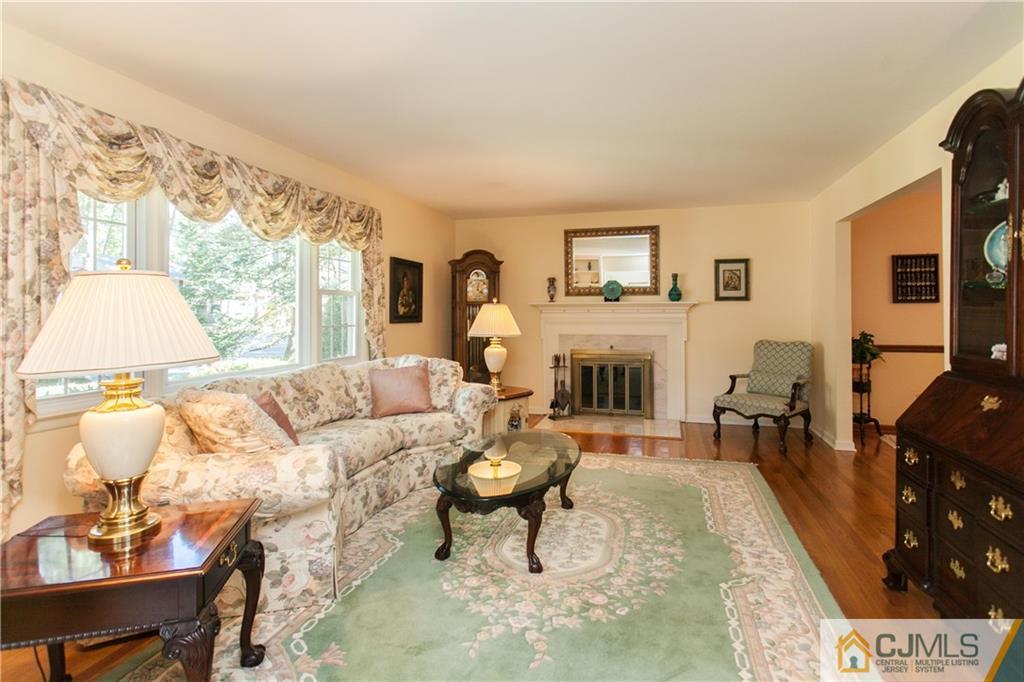 18 Huntington Road Edison, NJ 08820 - Photo 5 of 21 a living room with furniture a fireplace and a large window
