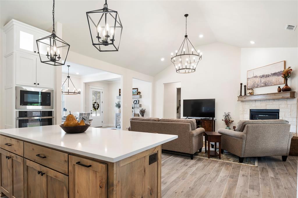704 Abbey Road Van Alstyne, TX 75495 - Photo 13 of 38 a view of a dining room with furniture a chandelier and wooden floor