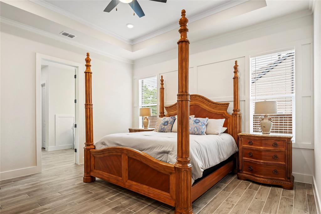 704 Abbey Road Van Alstyne, TX 75495 - Photo 19 of 38 a bedroom with a bed chandelier and a window