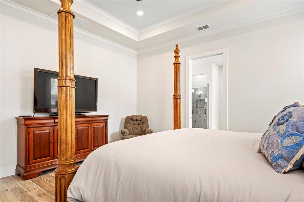 704 Abbey Road Van Alstyne, TX 75495 - Photo 21 of 38 a bedroom with a bed and wooden floor