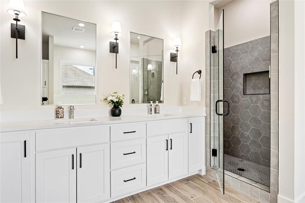 704 Abbey Road Van Alstyne, TX 75495 - Photo 22 of 38 a bathroom with a shower sink and mirror