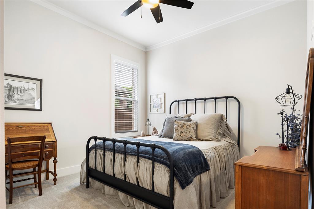 704 Abbey Road Van Alstyne, TX 75495 - Photo 28 of 38 a bedroom with a bed and a chandelier