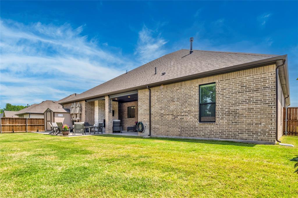 704 Abbey Road Van Alstyne, TX 75495 - Photo 32 of 38 a front view of house with yard outdoor seating and barbeque oven