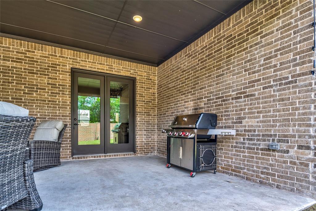 704 Abbey Road Van Alstyne, TX 75495 - Photo 35 of 38 a view of outdoor space with barbeque grill and brick wall