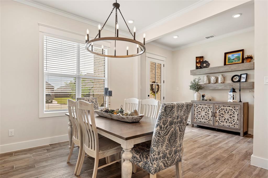704 Abbey Road Van Alstyne, TX 75495 - Photo 5 of 38 a view of a dining room with furniture window and wooden floor