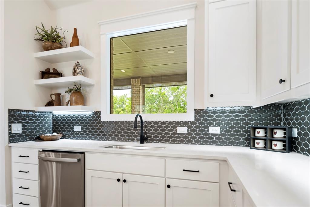 704 Abbey Road Van Alstyne, TX 75495 - Photo 9 of 38 a kitchen with white cabinets and window