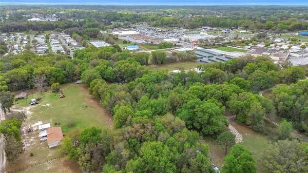 an aerial view of residential houses with outdoor space and river