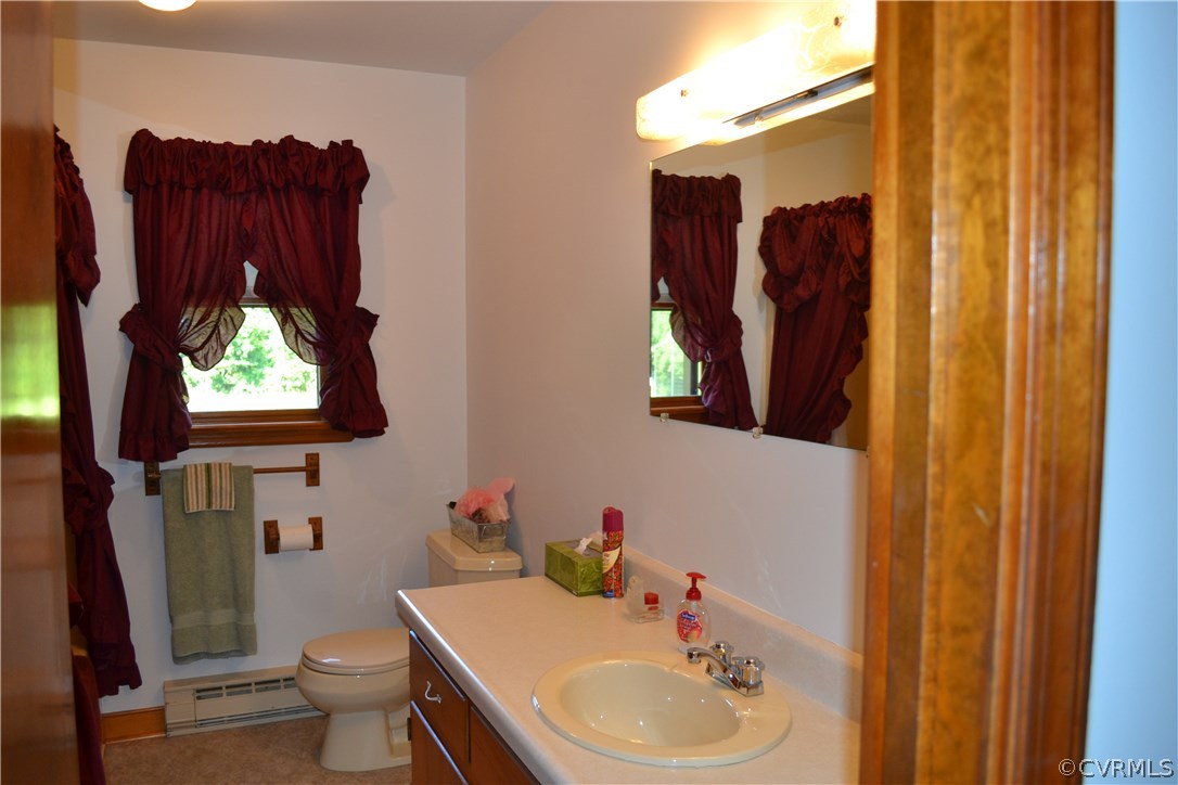 9711 Beaver Bridge Road Chesterfield, VA 23838 - Photo 19 of 24 a bathroom with a toilet sink and mirror