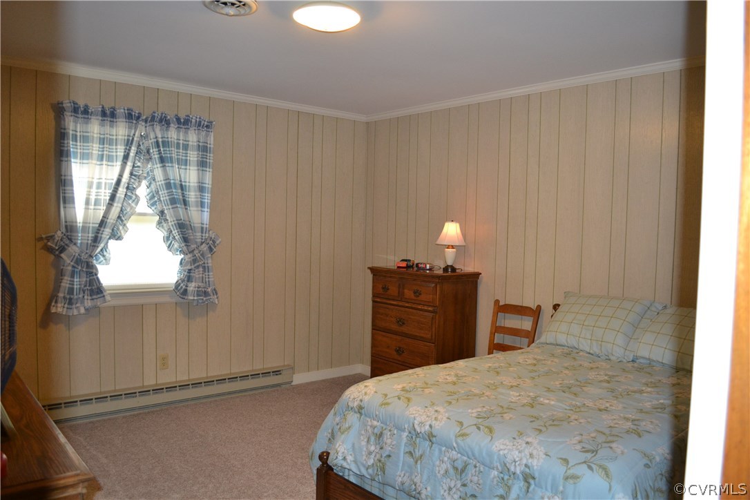 9711 Beaver Bridge Road Chesterfield, VA 23838 - Photo 20 of 24 a bedroom with a bed and wooden floor