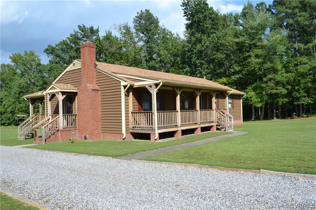 9711 Beaver Bridge Road Chesterfield, VA 23838 - Photo 2 of 24 a view of a house with a big yard and large trees