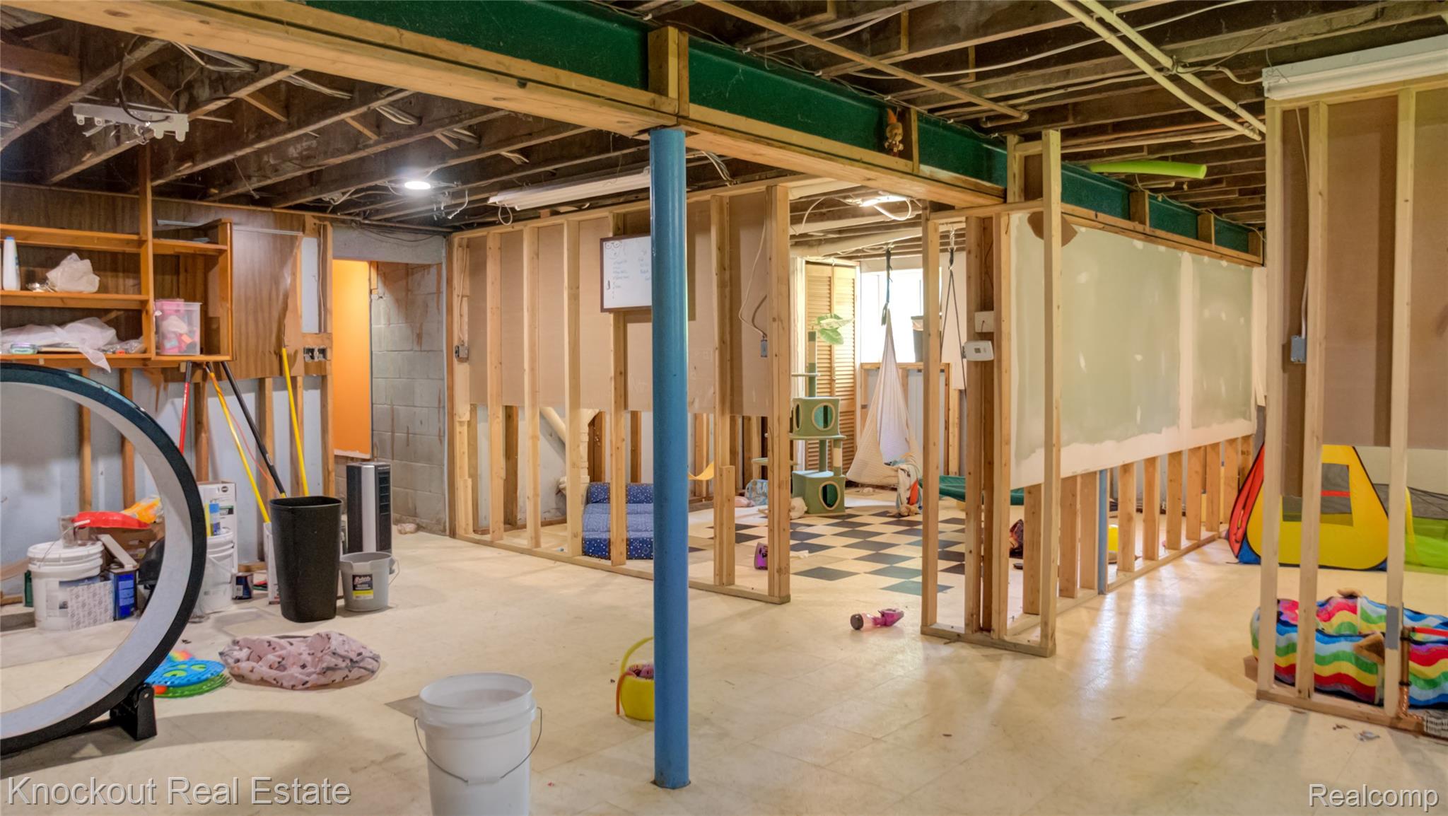 4195 Williamson Road Saginaw, MI 48601 - Photo 29 of 50 Unfinished basement featuring exposed ceiling joists, wood-frame wall construction, a supporting steel column, and a concrete floor