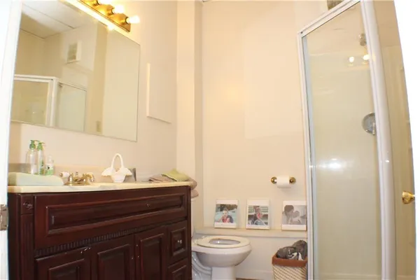 a bathroom with a sink a toilet and shower