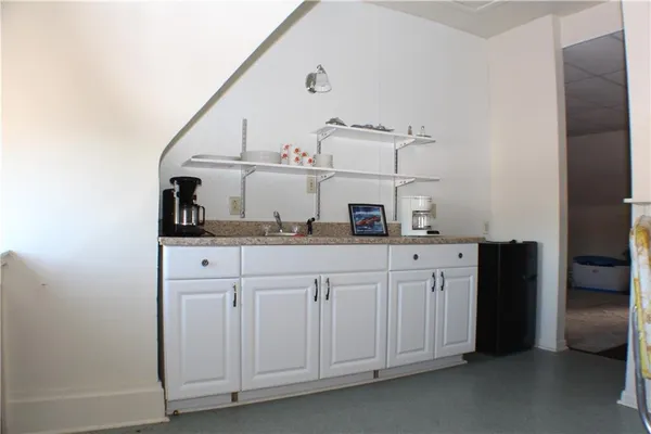 a kitchen with cabinets and white appliances