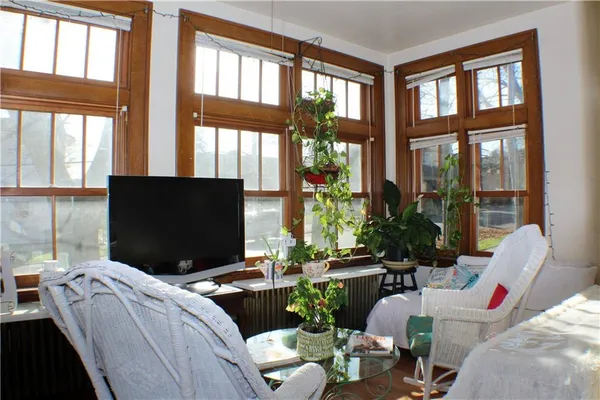 a living room with furniture tv and a large window