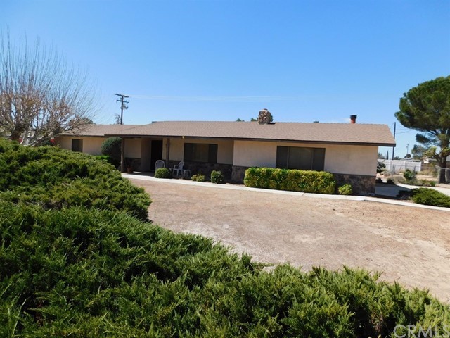 14412 Rincon Road Apple Valley, CA 92307 - Photo 1 of 1 a front view of a house with a yard and garage