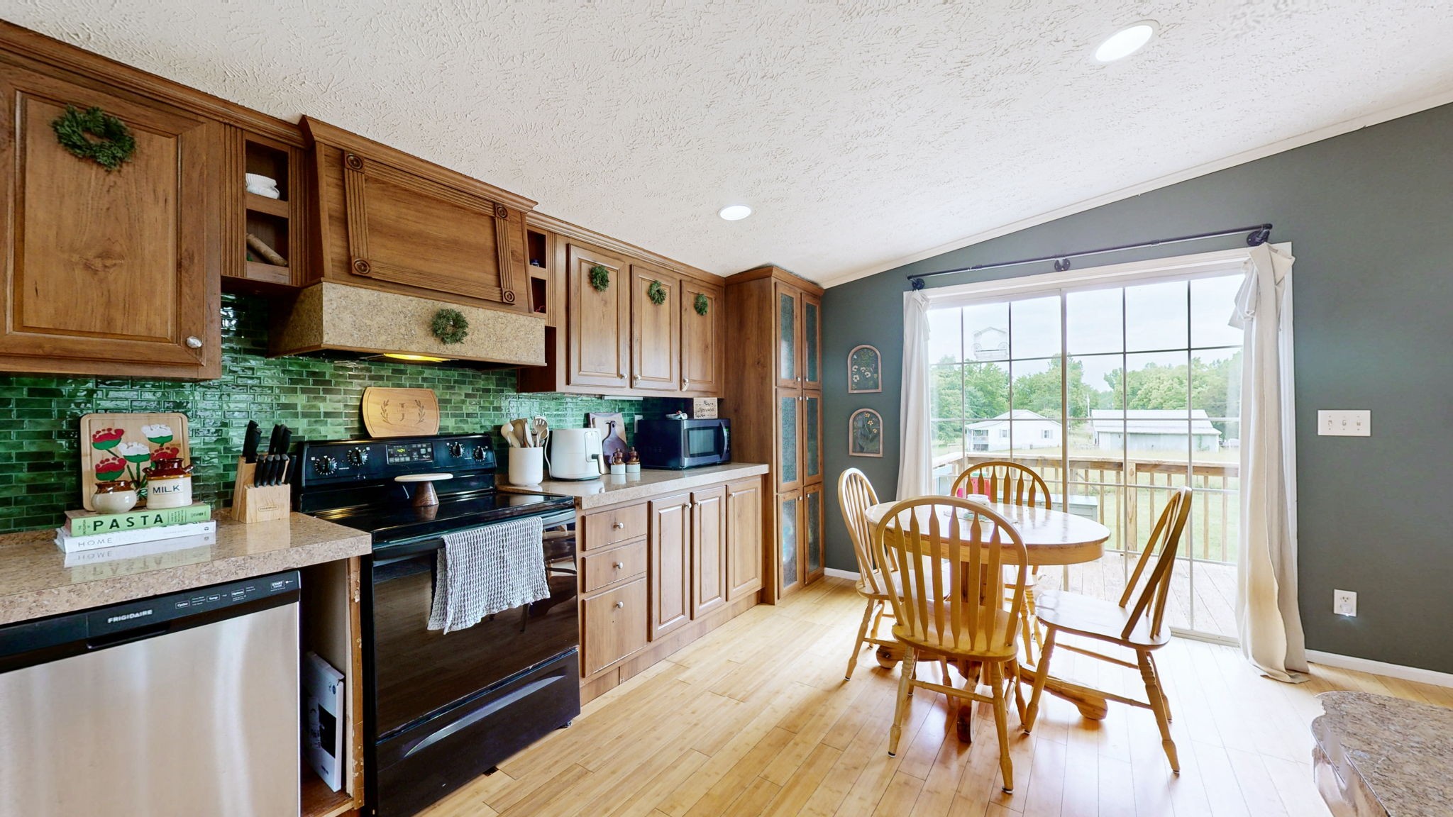 133 Cleveland Road Wartrace, TN 37183 - Photo 7 of 23 a kitchen with stainless steel appliances granite countertop a stove top oven a sink a dining table and chairs with wooden floor