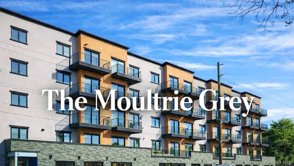 a front view of a brick building with glass windows