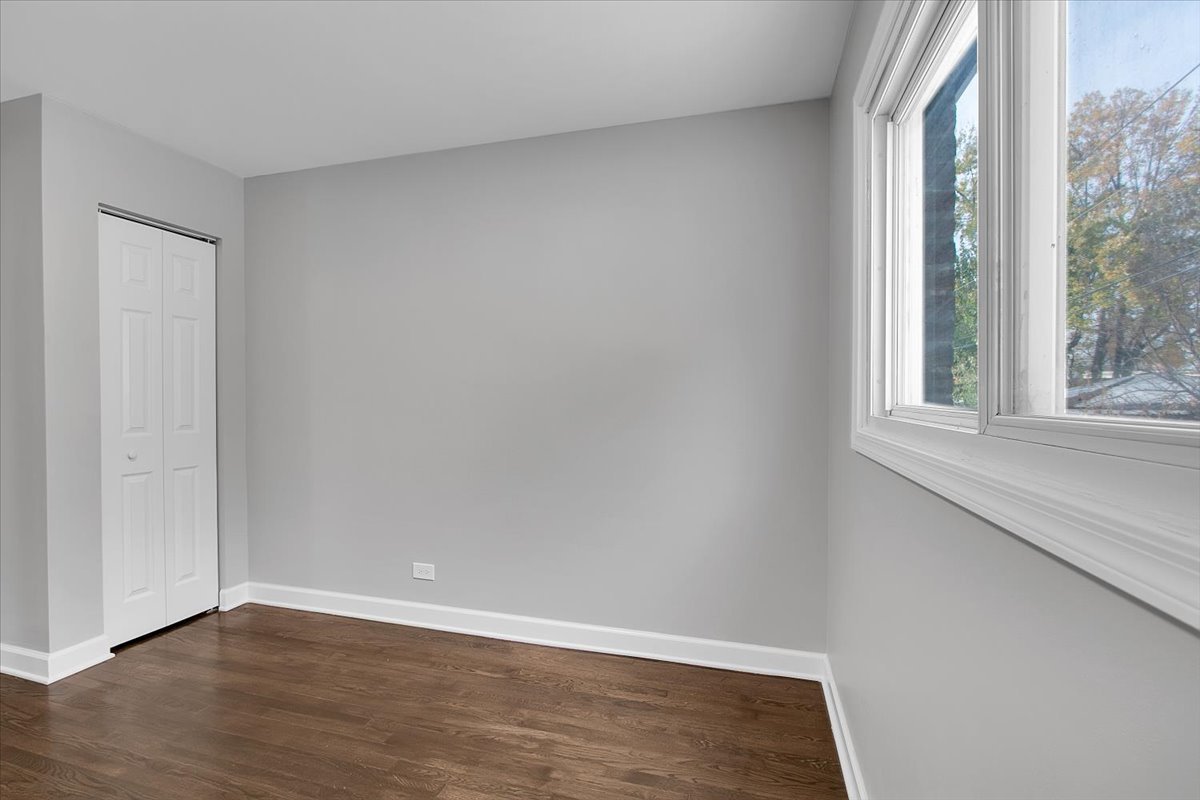 11524 South Kildare Avenue Alsip, IL 60803 - Photo 11 of 34 a view of an empty room with wooden floor and a window