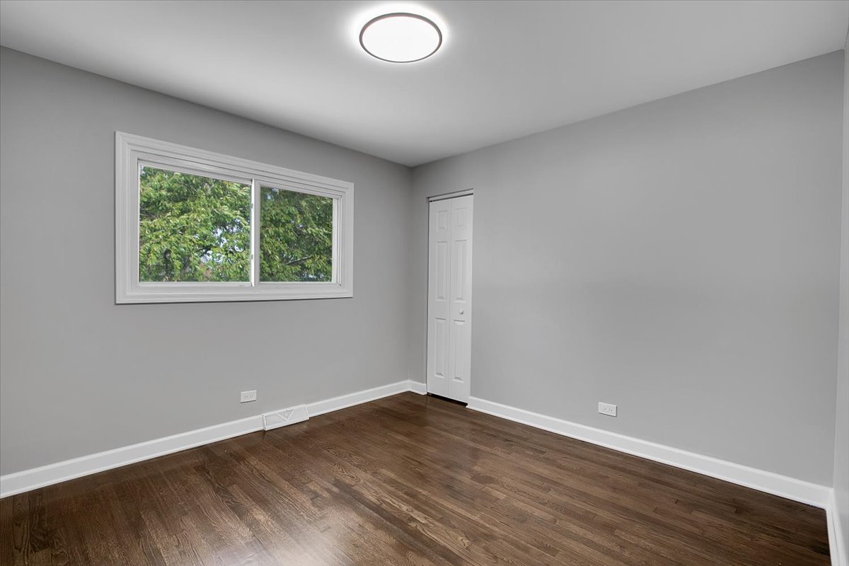 11524 South Kildare Avenue Alsip, IL 60803 - Photo 6 of 34 an empty room with wooden floor and windows