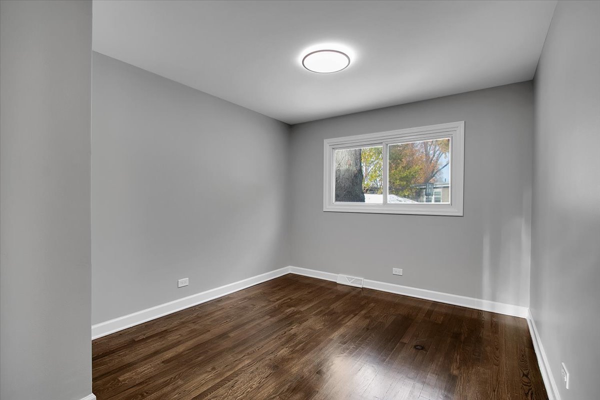 11524 South Kildare Avenue Alsip, IL 60803 - Photo 10 of 34 an empty room with wooden floor and windows