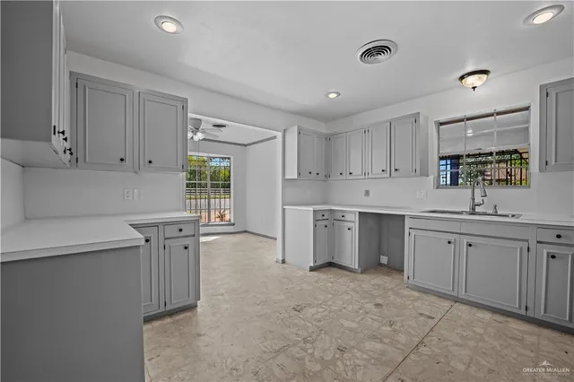 a kitchen with sink cabinets and window