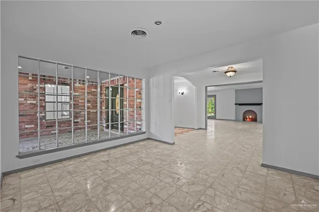 a view of empty room with furniture and window