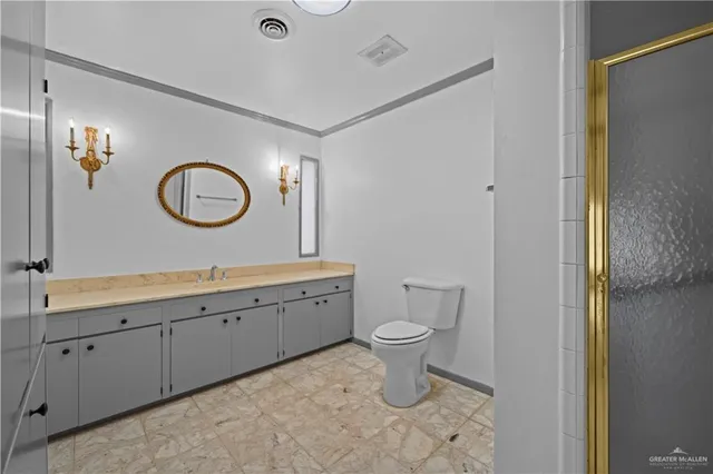 a bathroom with a toilet sink and shower