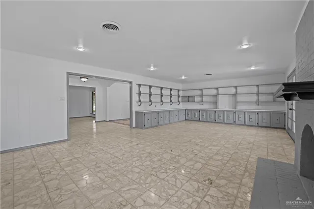 a view of a livingroom with a fireplace and window